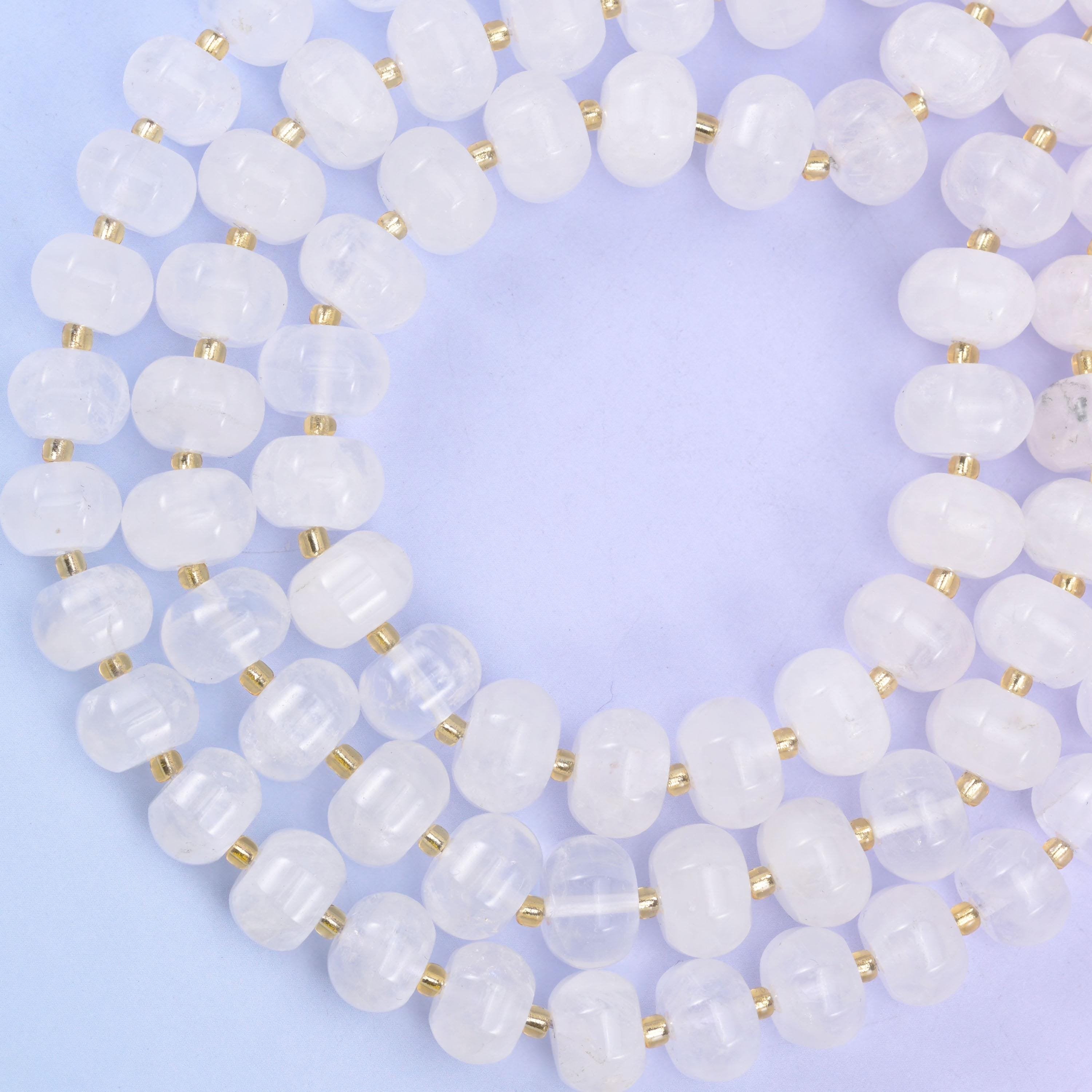 Open loop of pumpkin rondelles on lilac, beads evenly cut and closely matched