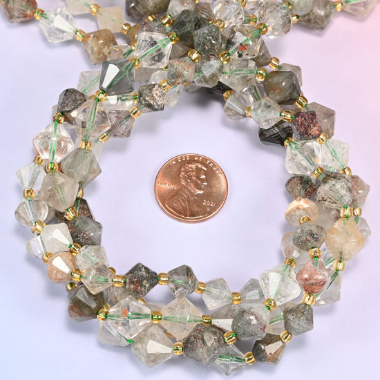 Close-up of Green Phantom Quartz faceted bicone beads, 8mm and 10mm, coiled into a circle, highlighting the internal green phantom inclusions.