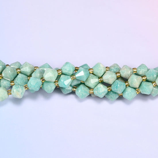 Green Amazonite faceted bicone beads 8mm with gold-tone spacers, close-up of the strand laid straight