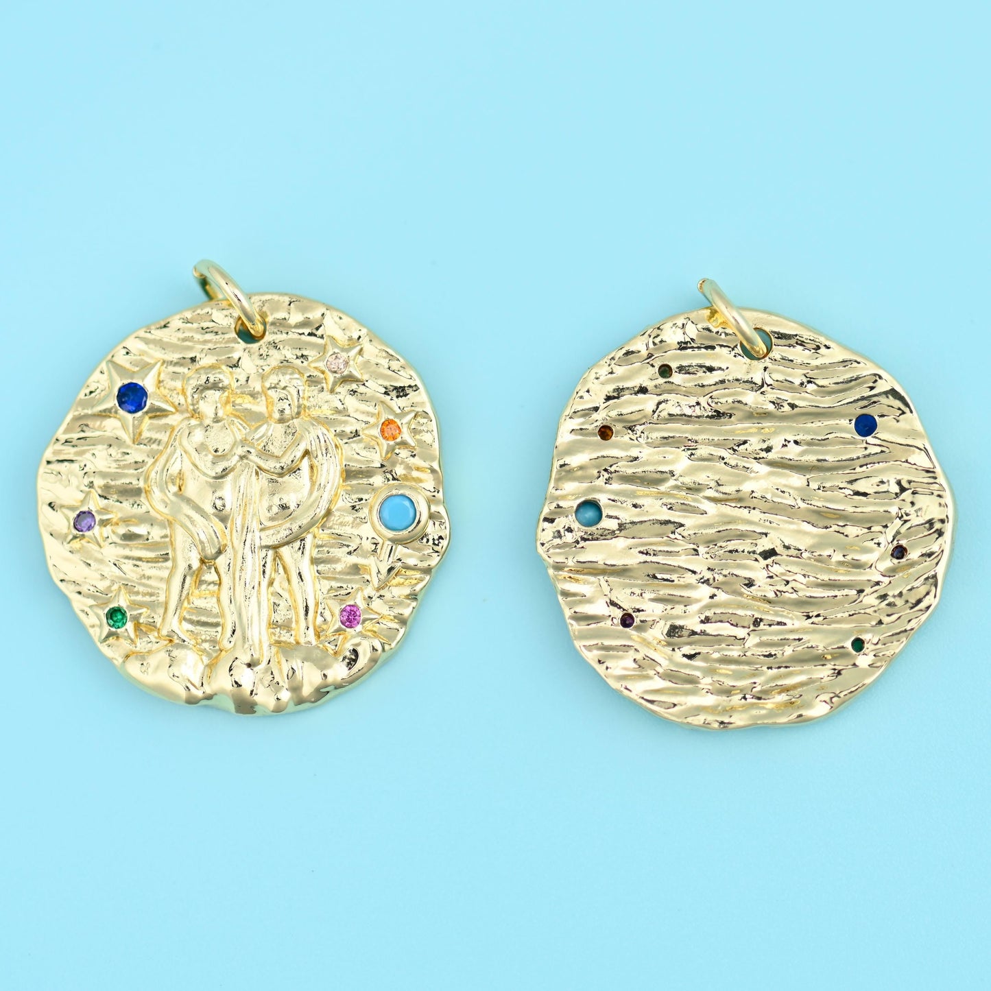 A hand-hammered gold disc with an irregular, slightly wavy edge, carrying a raised zodiac figure on the front and a scatter…