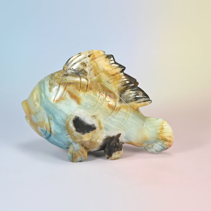 6 inch natural ocean agate fish carving, side view in aqua blue, cream and tan with charcoal patches