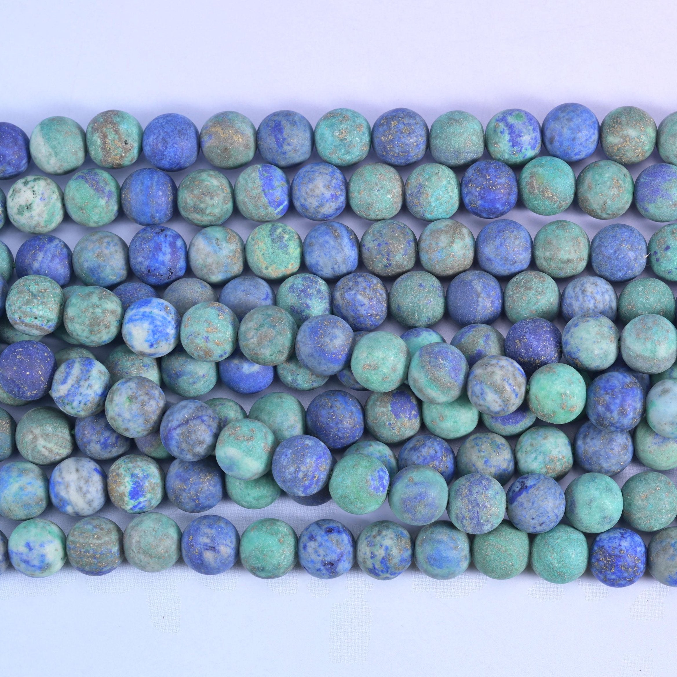 Sea green and turquoise blotched with deep royal blue and rust-brown, sanded to a frosted stone-dry finish