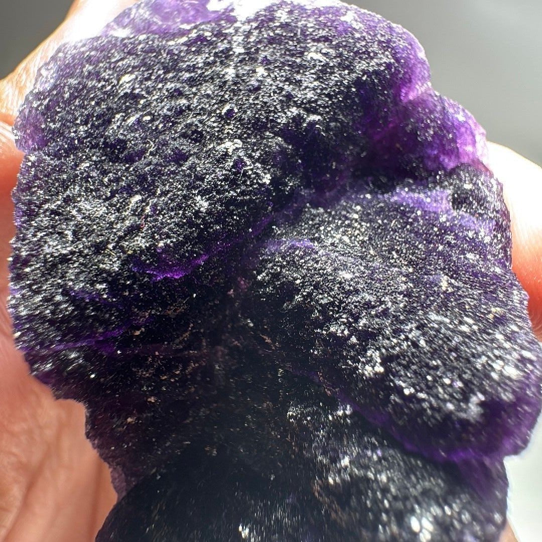 Detail of the fluorite specimen showing purple colour zoning under sugary quartz druzy.