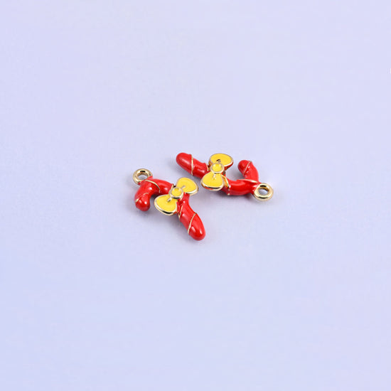 Three red candy cane charms at different angles, yellow enamel bows and raised gold stripes.