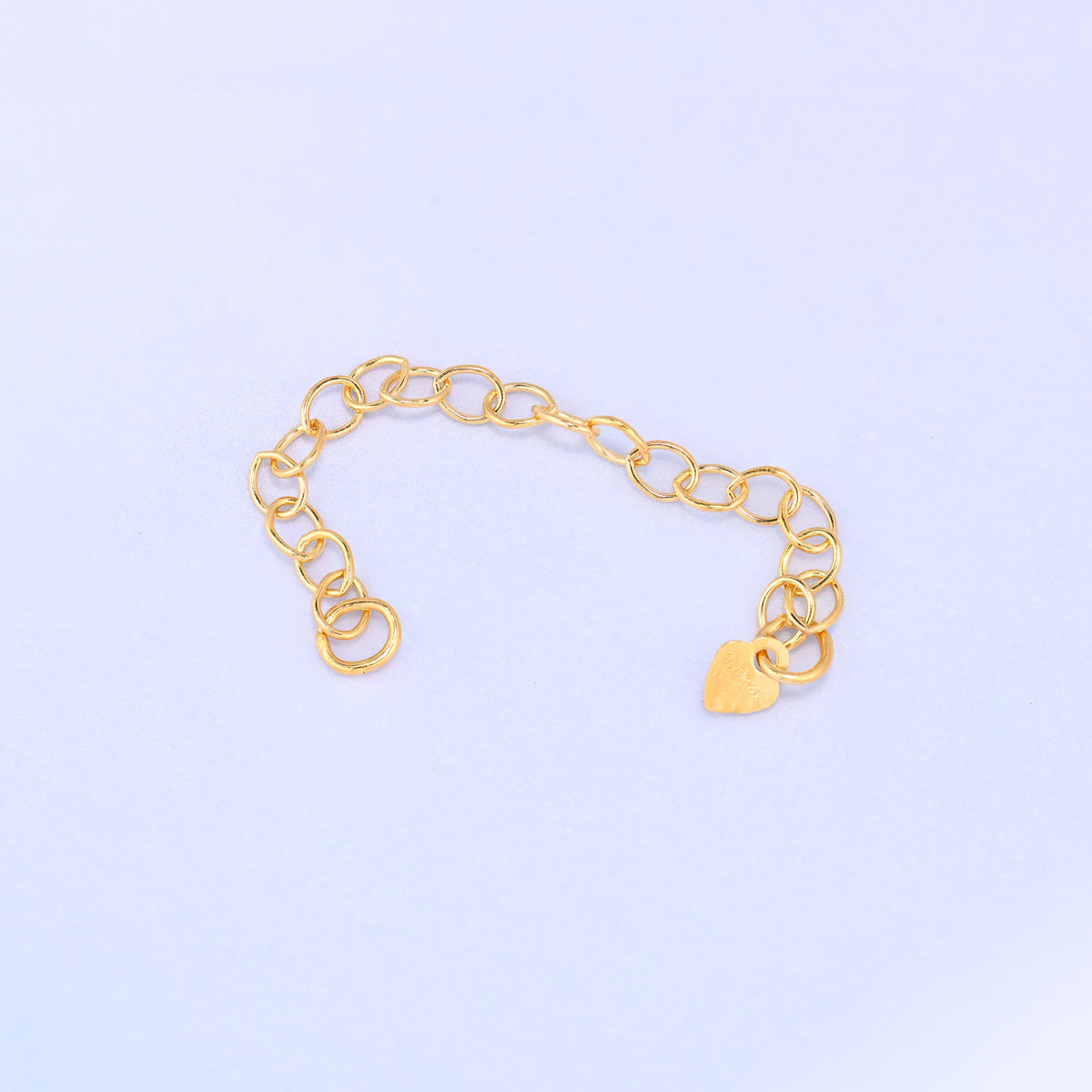 14K gold filled heart chain extender in a wide curve, heart charm and 1/20 14K stamp visible near the chain's end.