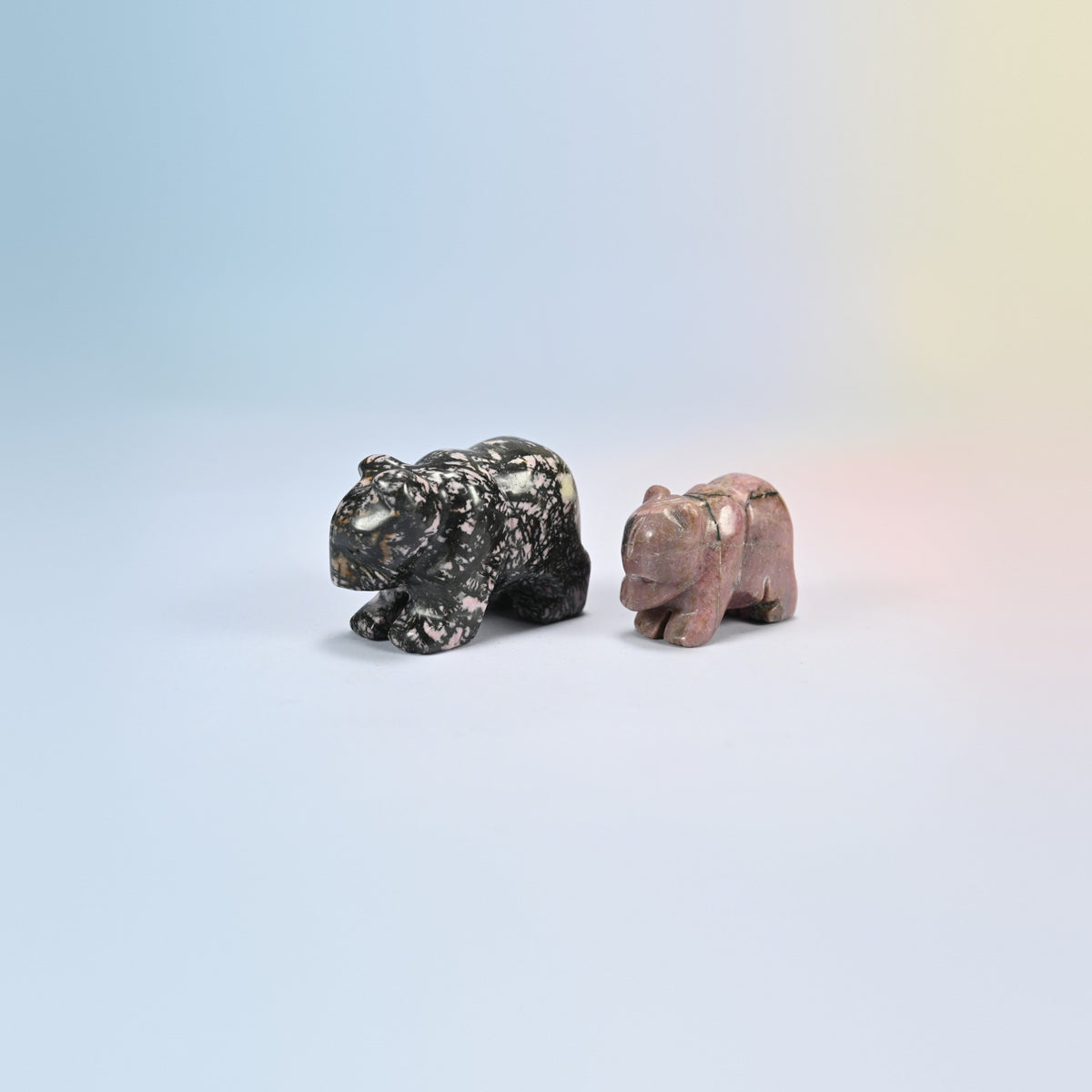 A 2 inch and a 1.5 inch rhodonite bear crystal carving, pink and black natural stone