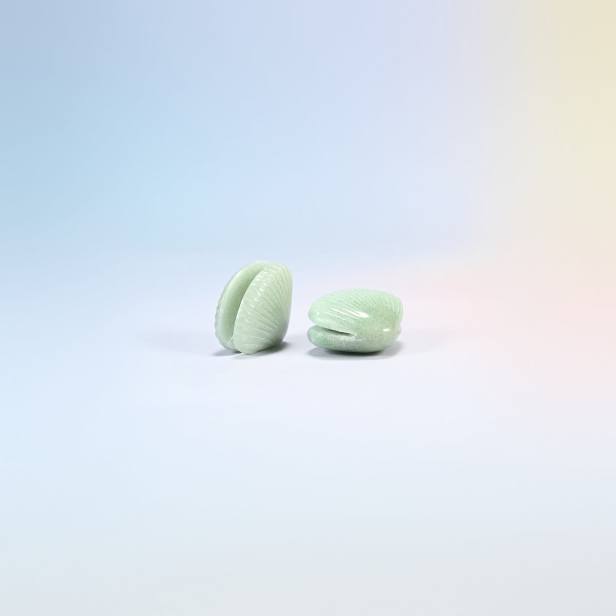 Two green aventurine clam shell crystal carvings, 1.5 inch, light green natural stone with ribbed shell lines