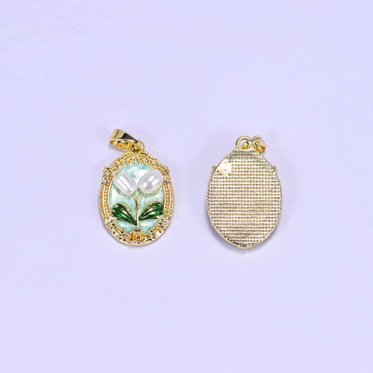 Enamel Oval Tulip Flower Pendants in mint shown front and reverse, the back a textured gold plated oval with the bail at the top.