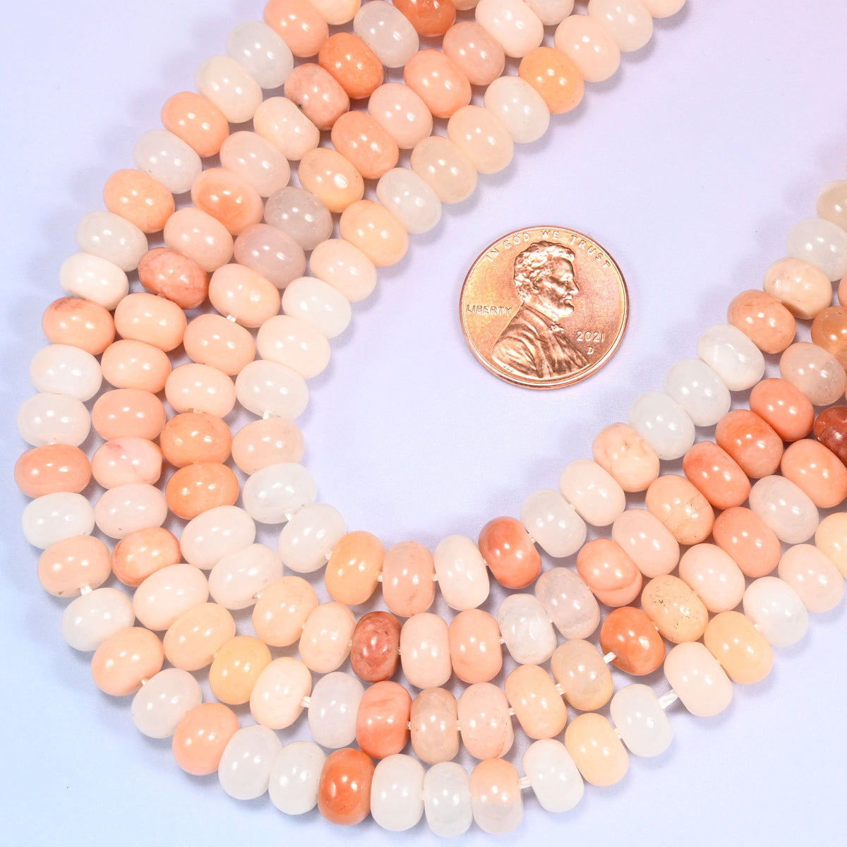 Rondelle cut Natural Pink Aventurine beads with subtle natural mineral inclusions.