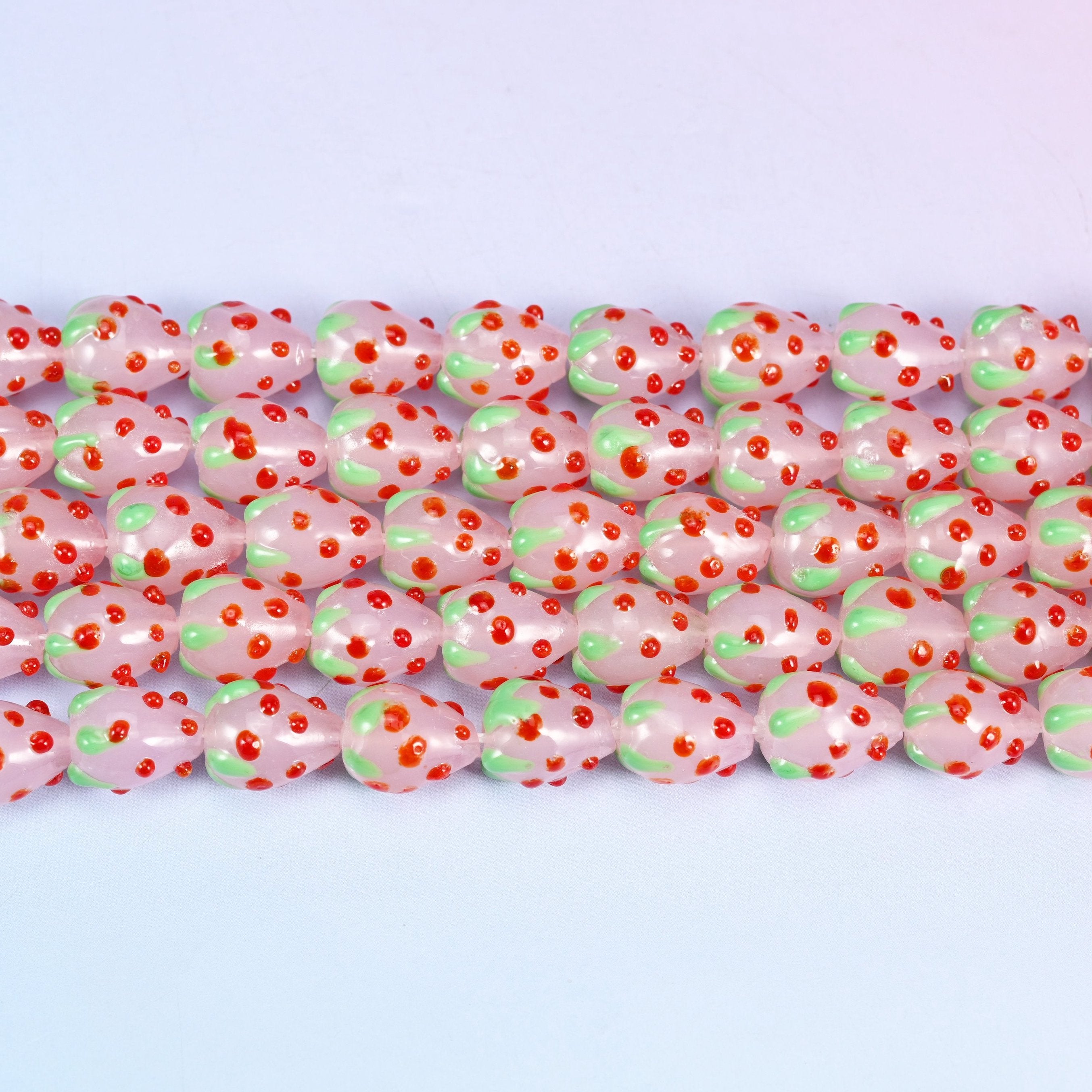 Pink Red Dots Strawberry Glass Beads in milky pink with a pale green leafy crown
