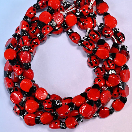 Red Ladybug Glass Beads, man-made glass with spots applied by hand.