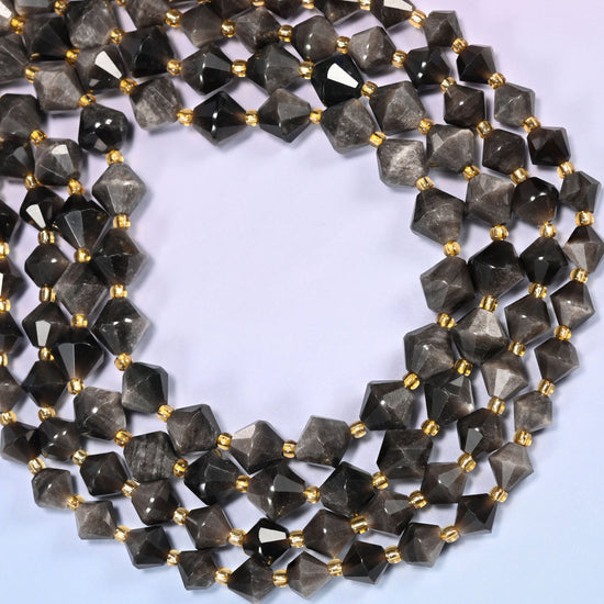 Silver obsidian bicone beads formed into a wide open ring, bright white highlights running along the facet edges.