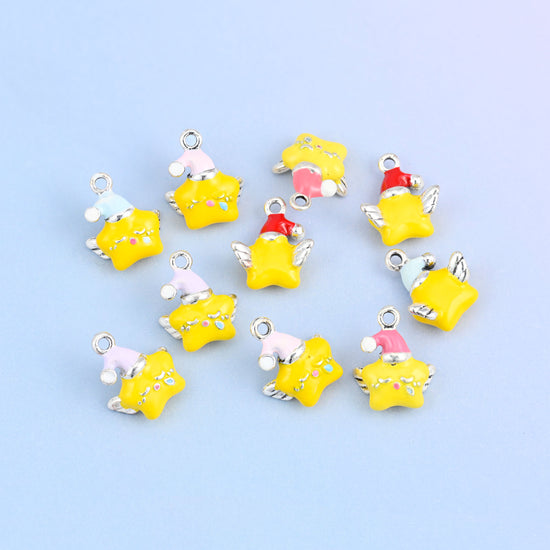 Eleven star charms with wings scattered in a group, yellow enamel stars in red, pink, light pink, light blue and light purple hats.