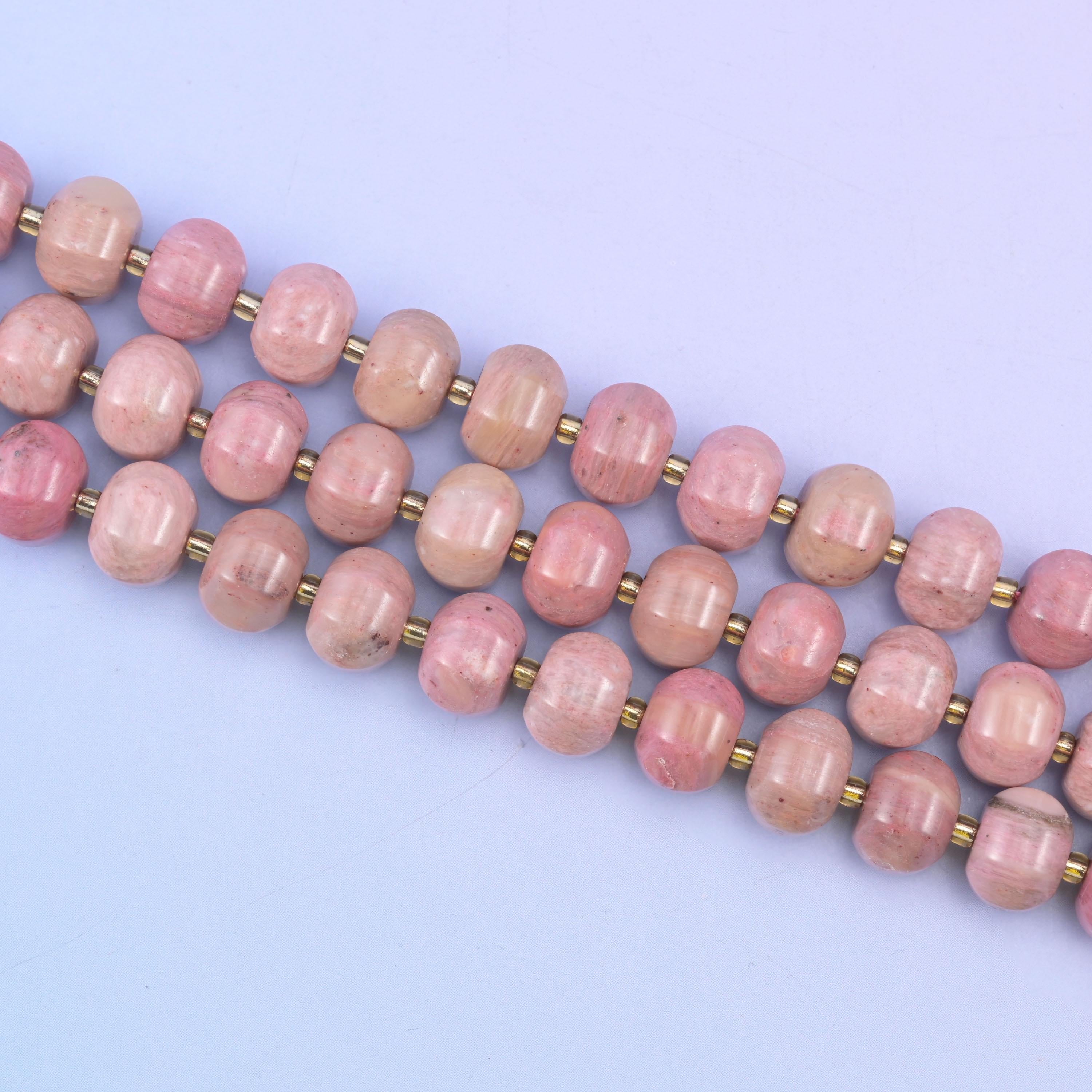 Pink rhodonite beads in warm mauve-pink with soft tonal shading
