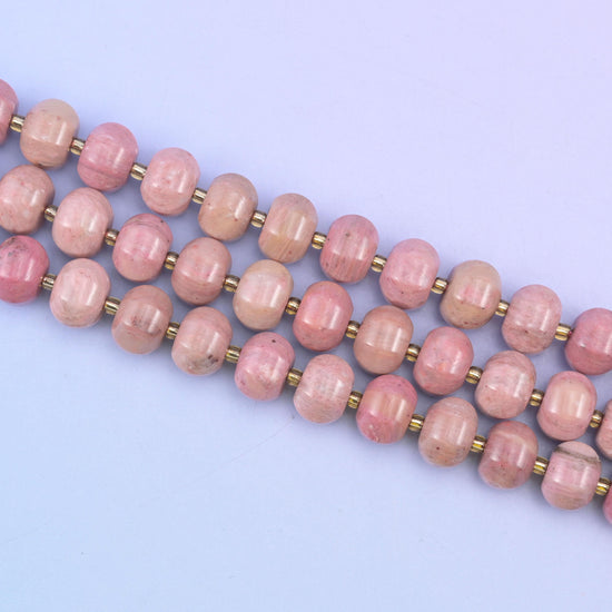 Pink rhodonite beads in warm mauve-pink with soft tonal shading