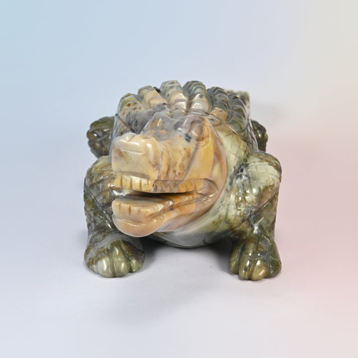 Front view of the Indian agate crocodile carving, pale tan head and open jaw with carved teeth
