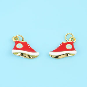 18K gold plated enamel sneaker pendants in red, two high-top shoe charms facing opposite ways with white trim and gold soles.