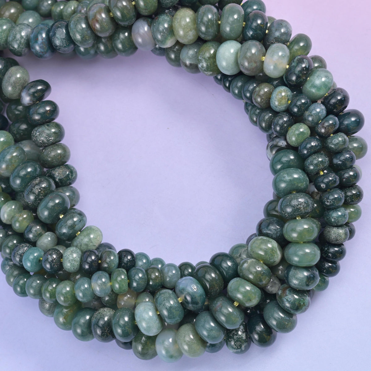 Moss agate smooth rondelle beads, several strands coiled into a loop.