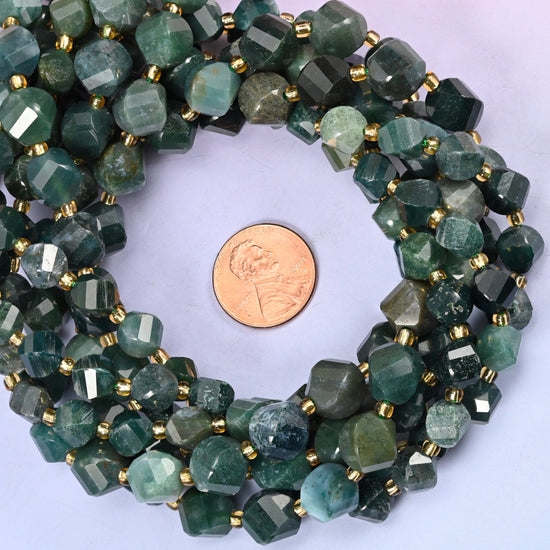 Moss Agate faceted spiral twist bead strands coiled around a US penny for size reference