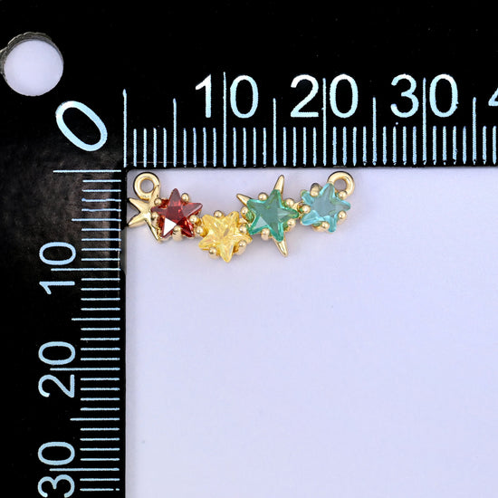 A multicolour four star zircon connector photographed beside a millimetre ruler for scale