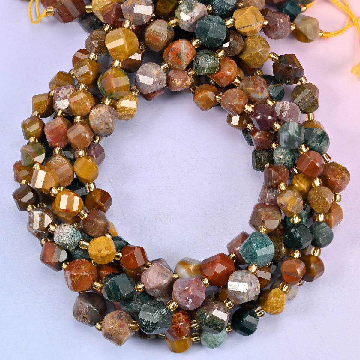 Ocean Agate faceted spiral twist beads, close view of the coiled strands mixing teal, mustard, rust and cream