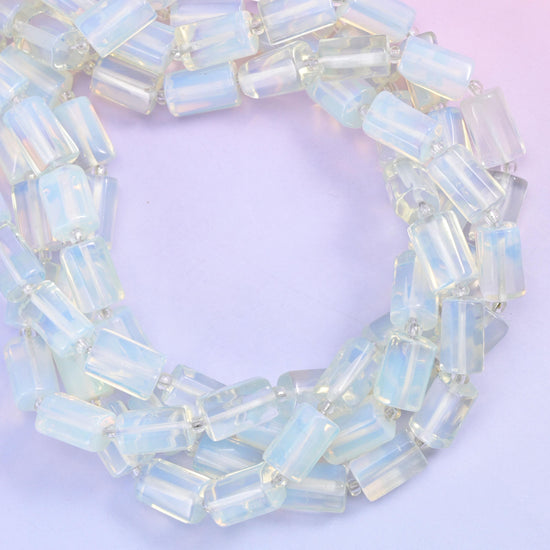 Opalite faceted tube beads coiled into a loop, man-made glass with an opalescent glow.