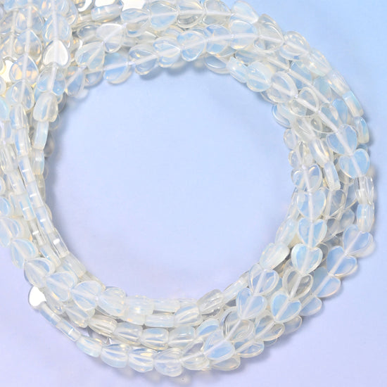 Opalite flat heart beads, close view of the coiled strands of milky translucent white hearts