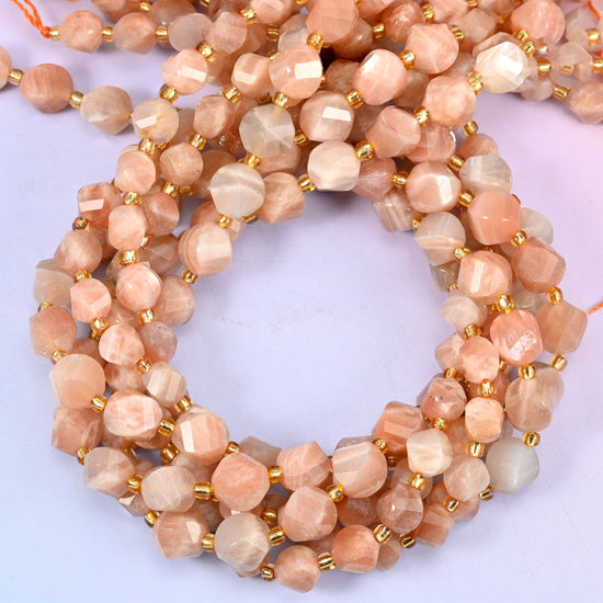 Orange Sunstone faceted spiral twist beads, close view of the coiled strands in peach and cream with gold spacer beads