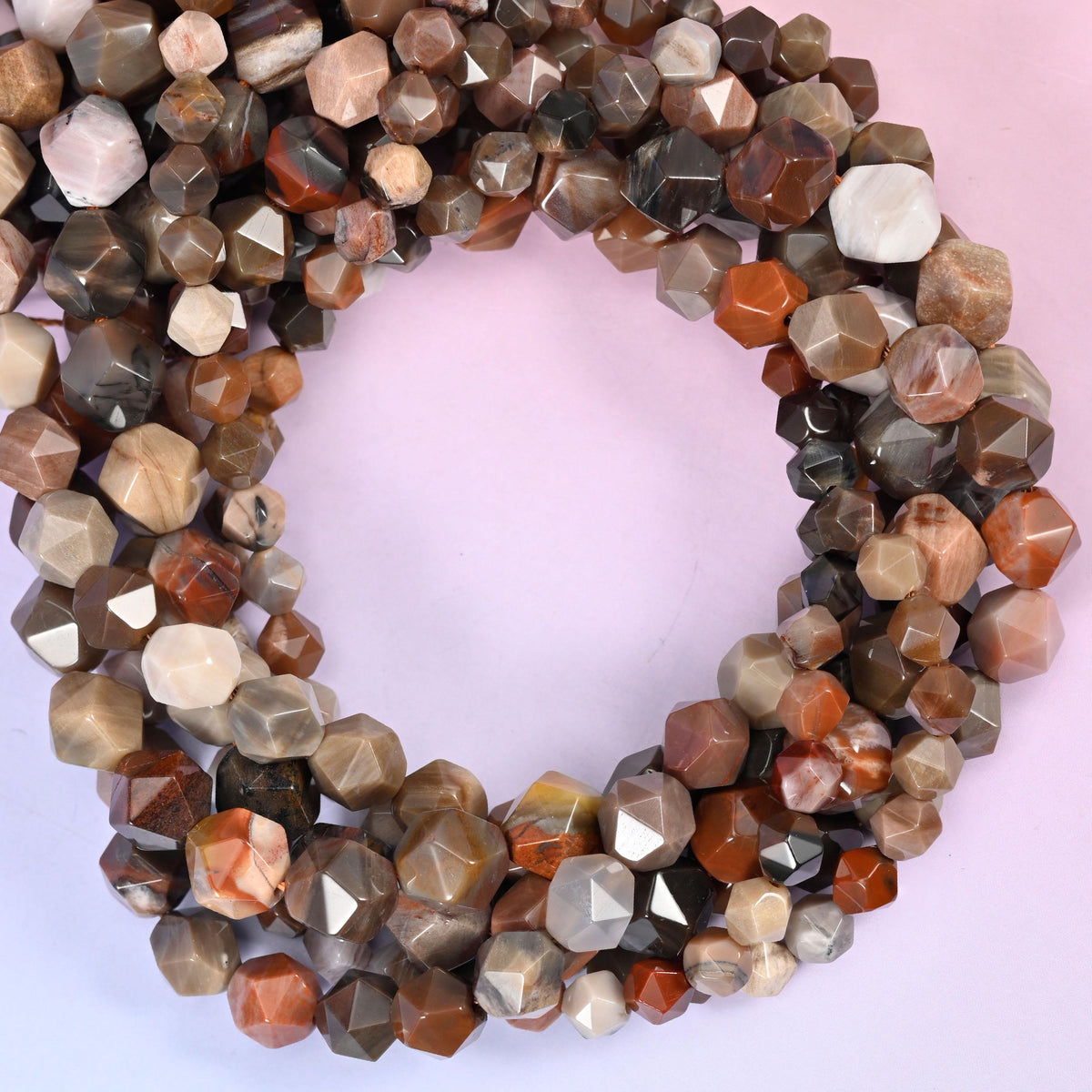 Petrified Wood faceted diamond star cut beads, close view of the coiled strands mixing warm brown, rust and cream