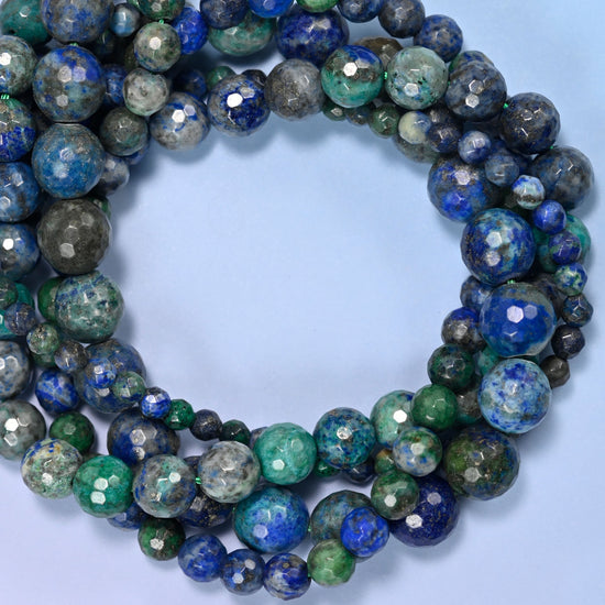 Phoenix Lapis faceted round beads, close view of the coiled strands showing deep blue, green and grey