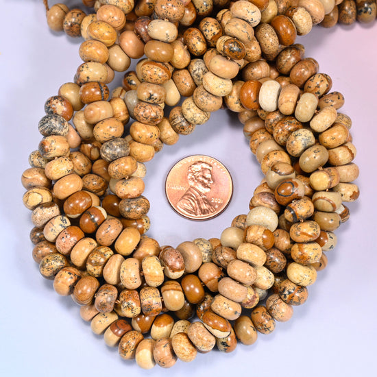 Picture Jasper rondelle bead strands coiled around a US penny for size reference