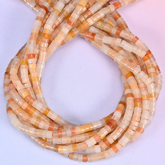 Pink Aventurine smooth heishi disc beads, close view of the coiled strands showing soft peach-pink with cream and apricot banding