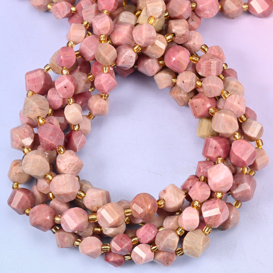 Pink Rhodonite faceted spiral twist beads, close view of the coiled strands showing dusty pink with tan and grey markings