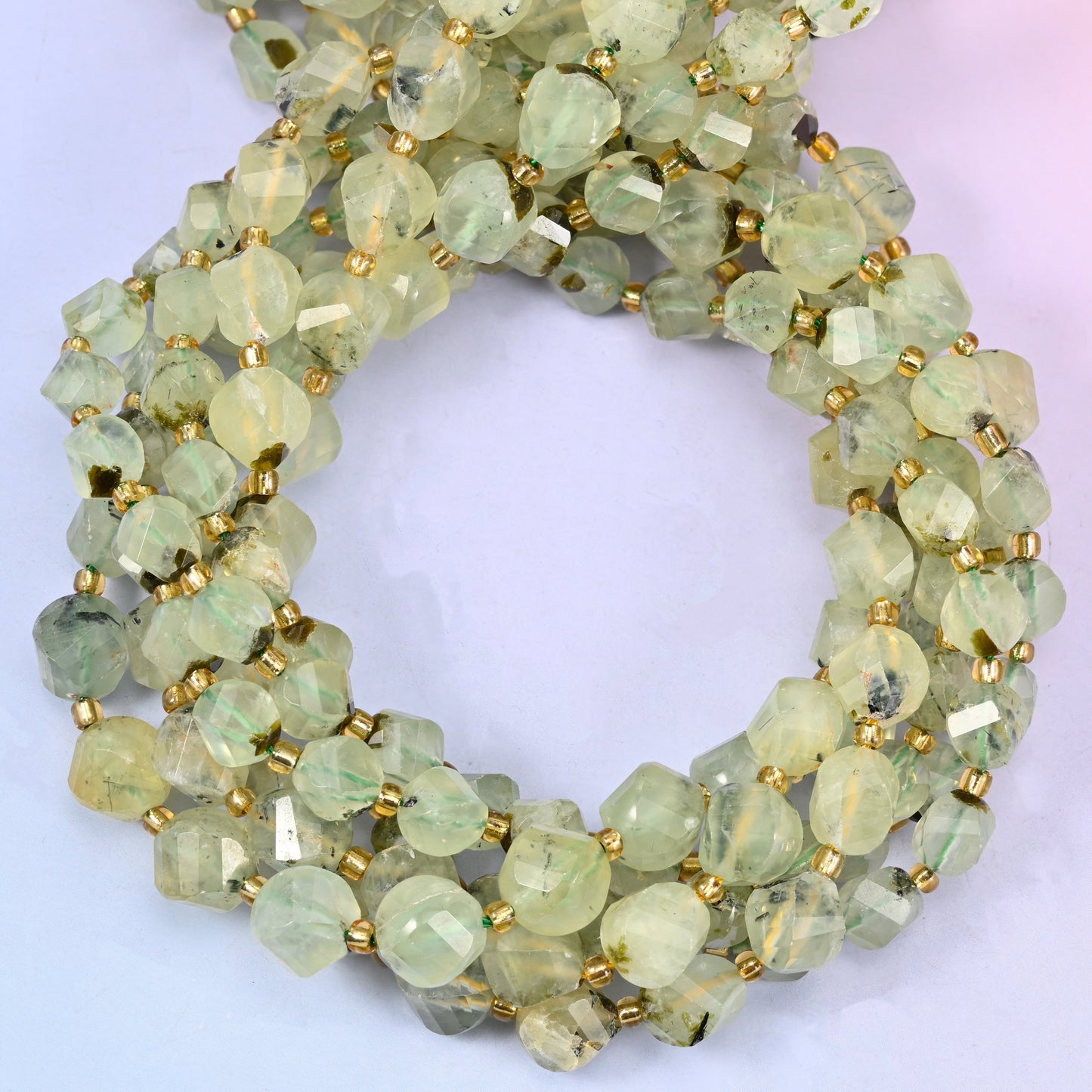 Prehnite faceted spiral twist beads, close view of the coiled strands showing the soft yellow-green colour