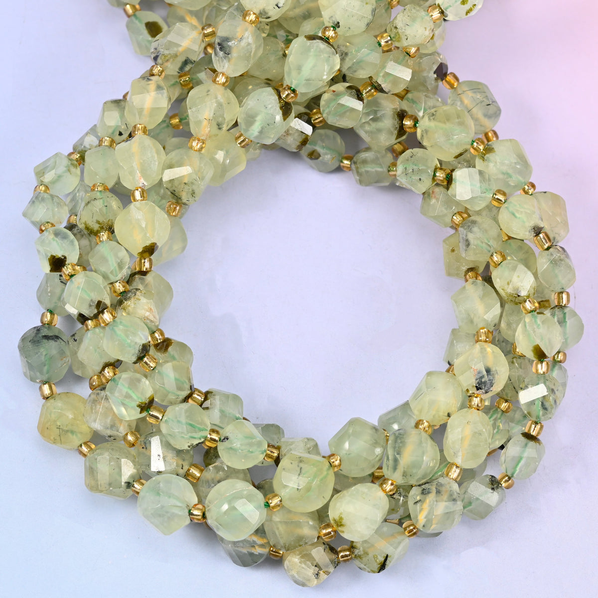 Prehnite faceted spiral twist beads, close view of the coiled strands showing the soft yellow-green colour