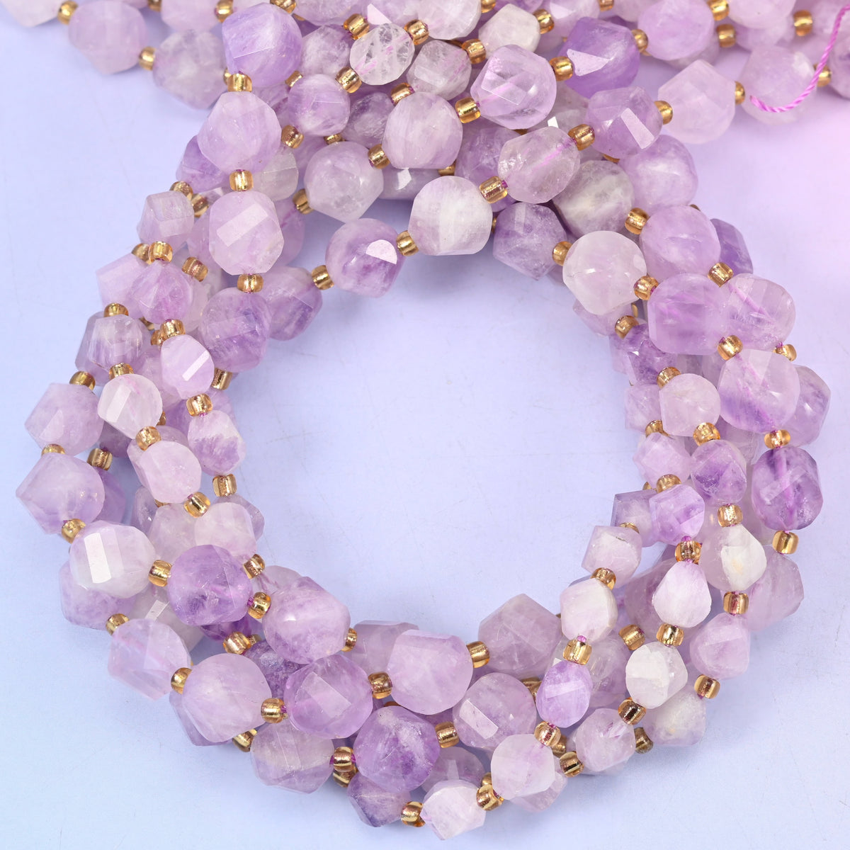 Purple Jade faceted spiral twist beads, close view of the coiled strands showing soft lilac with white patches
