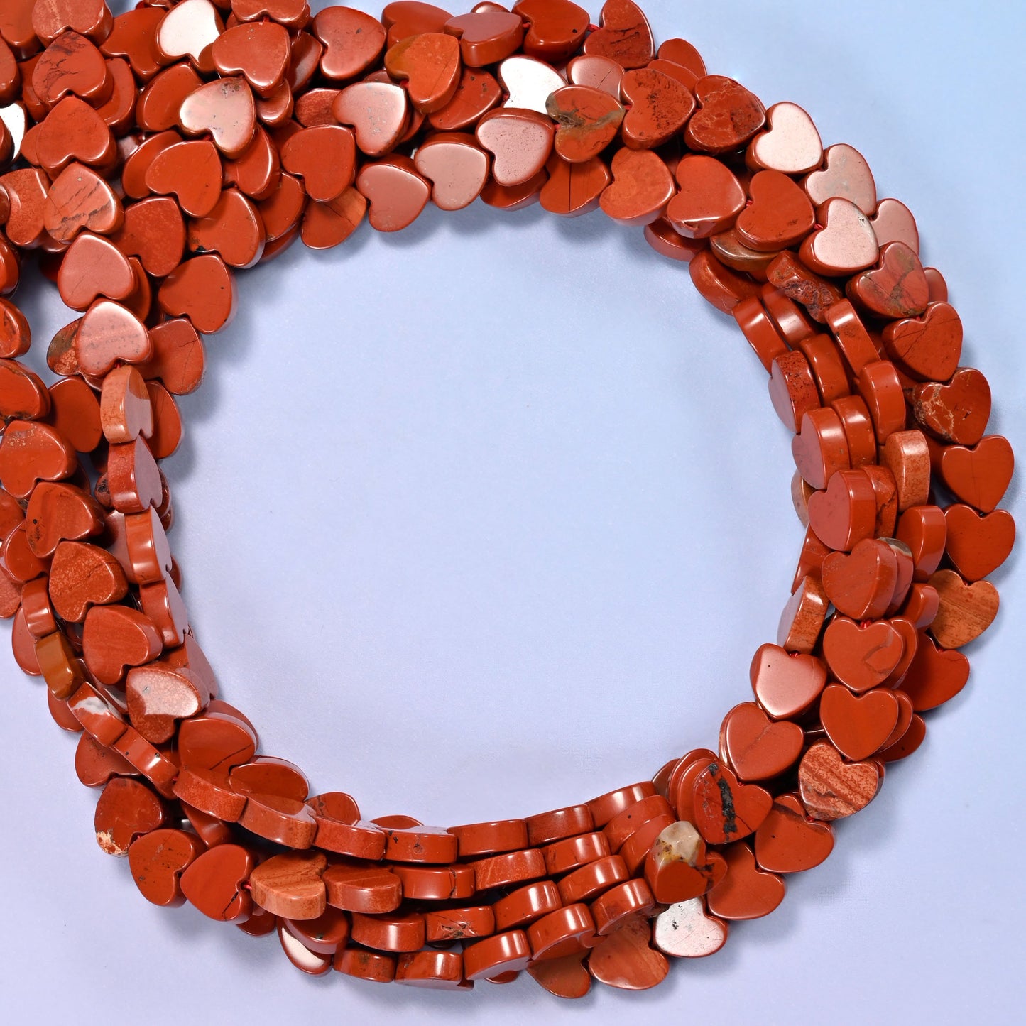 Red Jasper flat heart beads, close view of the coiled strands in brick red