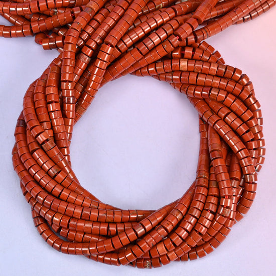 Red Jasper smooth heishi disc beads, close view of the coiled strands showing the even brick-red colour