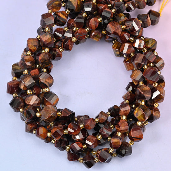 Red Tiger Eye faceted spiral twist beads, close view of the coiled strands showing deep red-brown bands with darker stripes