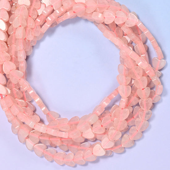 Rose Quartz flat heart beads, close view of the coiled strands in soft pink
