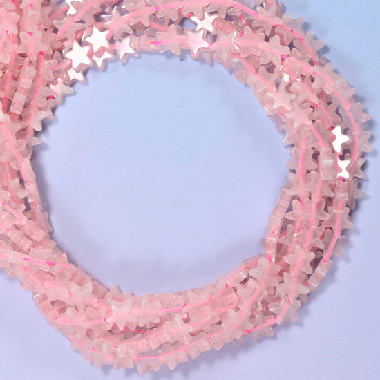 Rose Quartz flat star beads, close view of the coiled strands in soft pink