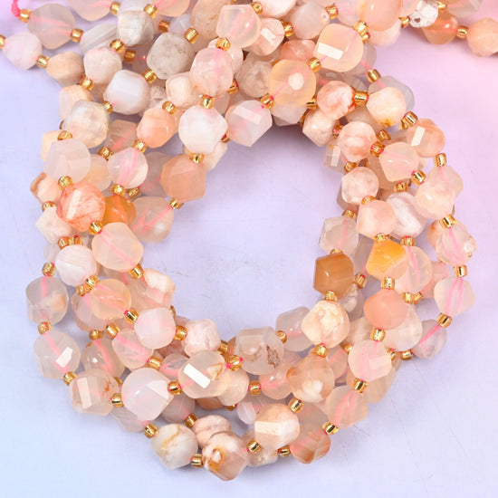 Sakura Flower Agate faceted spiral twist beads, close view of the coiled strands showing cream and soft peach with apricot flecks