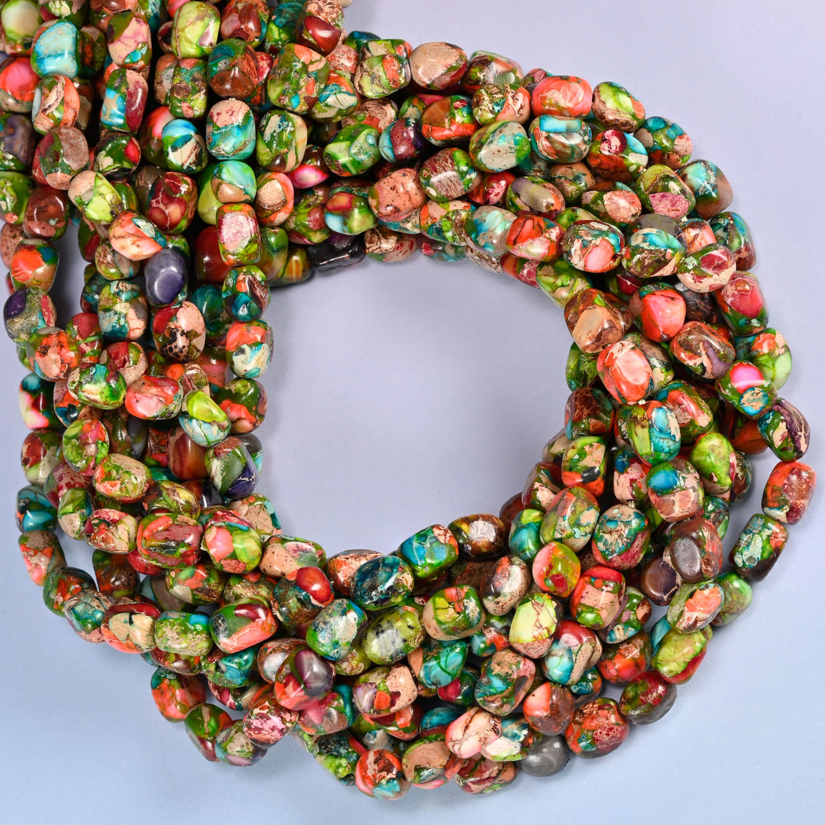 Dyed Sea Sediment Jasper nugget beads, close view of the coiled strands mixing green, red and turquoise