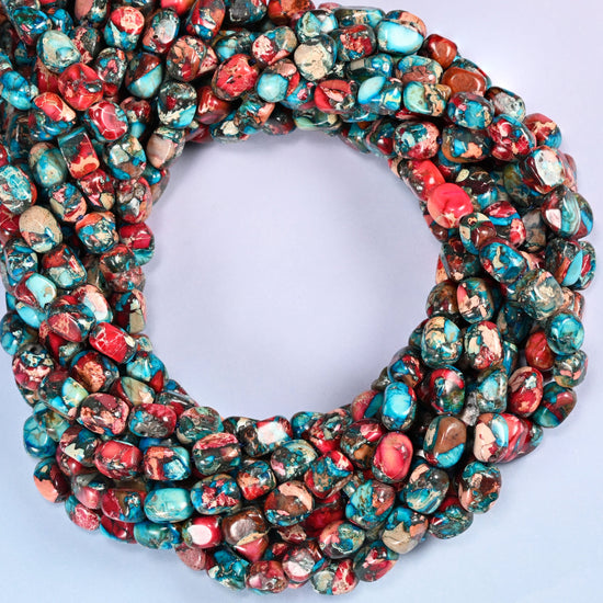 Dyed Sea Sediment Jasper nugget beads, close view of the coiled strands mixing red, turquoise and brown
