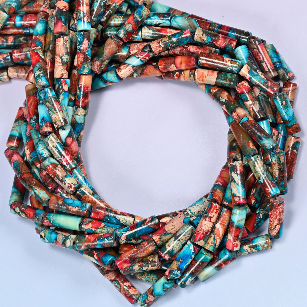 Sea Sediment Jasper tube beads, close view of the coiled strands mixing turquoise, red and brown