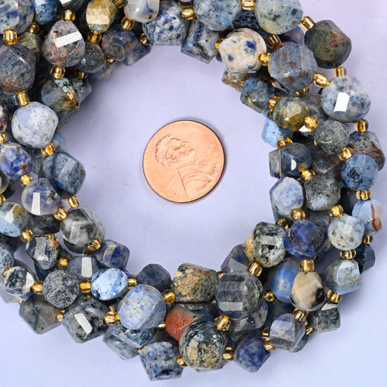 Sunset Dumortierite faceted spiral twist bead strands coiled around a US penny for size reference