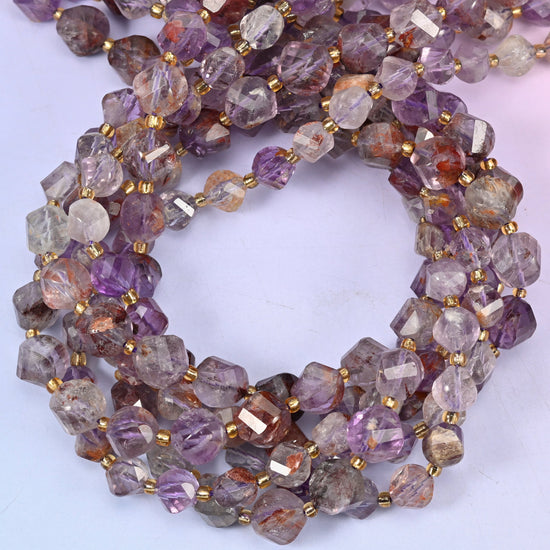 Super 7 Phantom faceted spiral twist beads, close view of the coiled strands showing translucent purple and smoky grey with rust inclusions