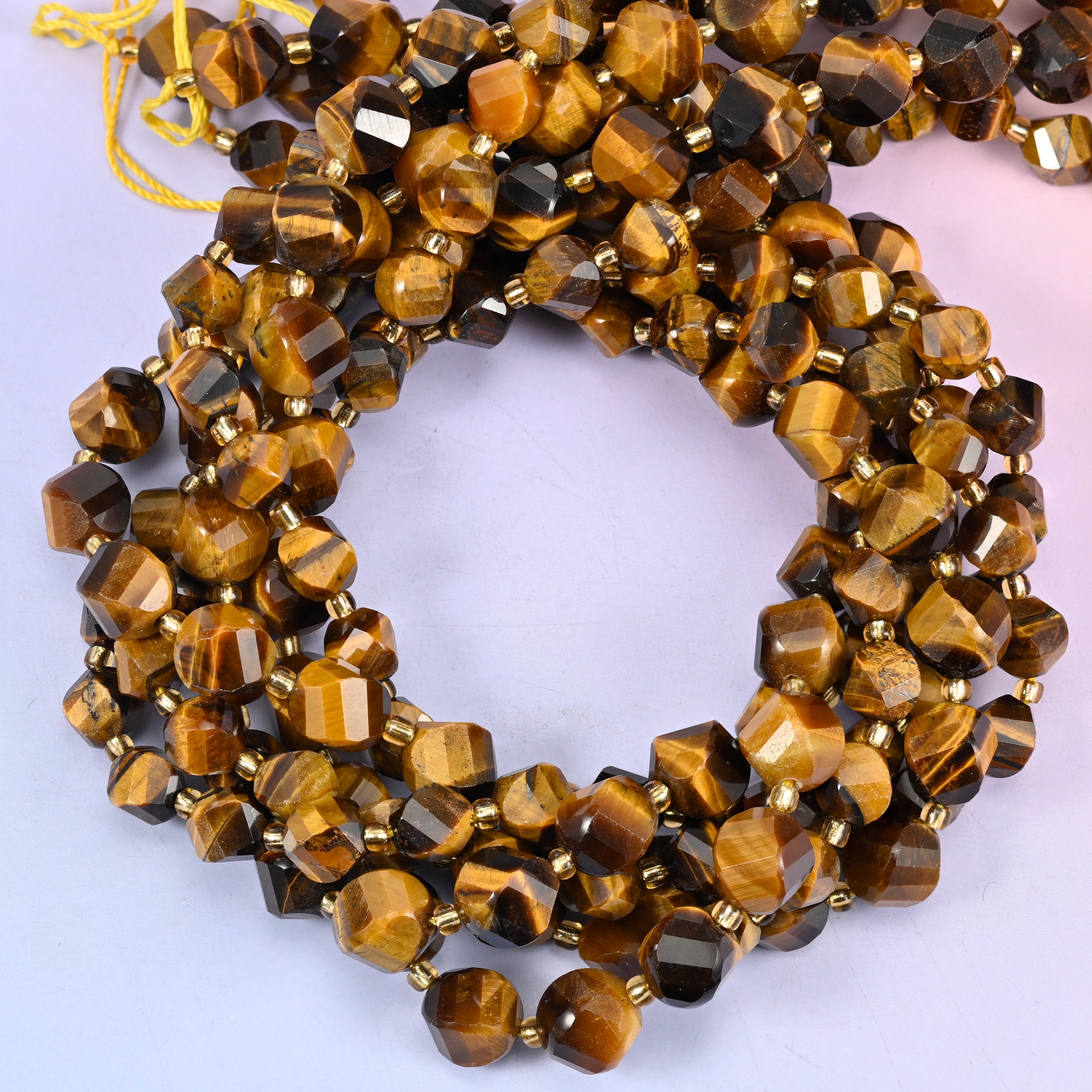 Tiger Eye faceted spiral twist beads, close view of the coiled strands showing golden brown bands with darker stripes