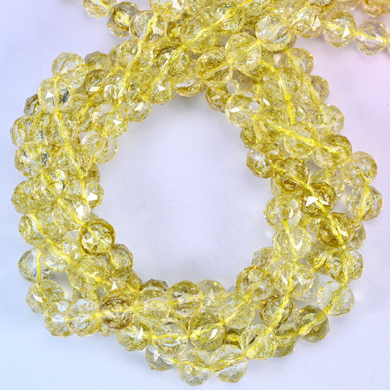 Transparent lemon yellow faceted round glass beads, close view of the coiled strands showing clear lemon yellow