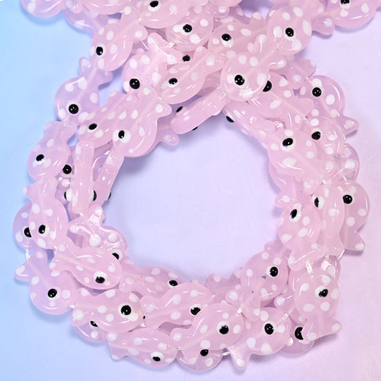 Transparent Pink with White Dot Fish glass beads, close view of the coiled strands in soft pink with white spots